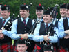 Happy band members pose for pictures at the European Championships. Left to right: Gavin Noade, Ryan Canning, Kyle Warren, Jamie Walker, Megan Canning, Conor McCallion, Ashley McMichael and Gareth McLees at the front and centre